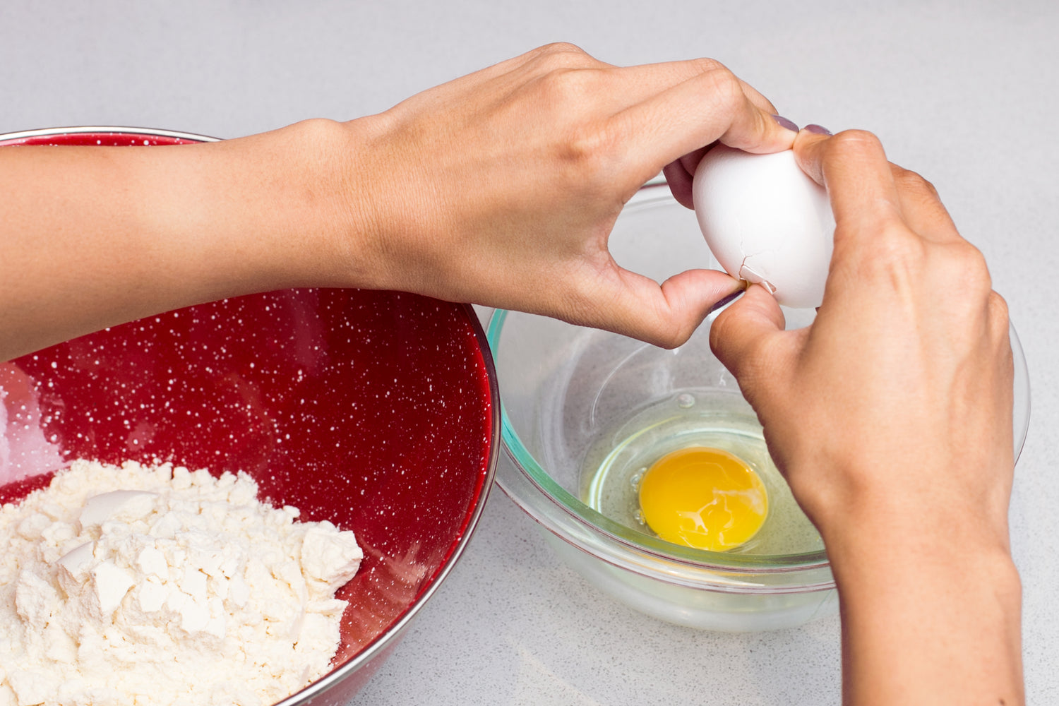 Close-up shot of an egg being cracked, preparing for a baking session.