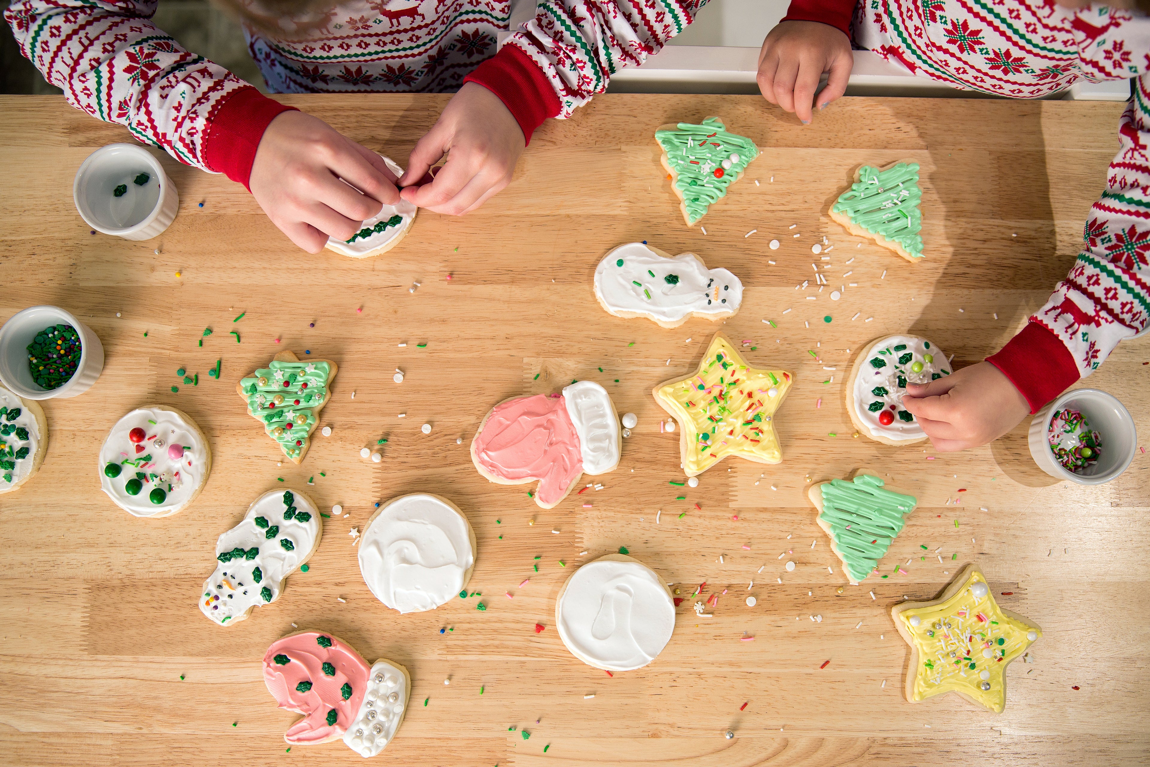 Group of kids happily decorating and enjoying cookies.