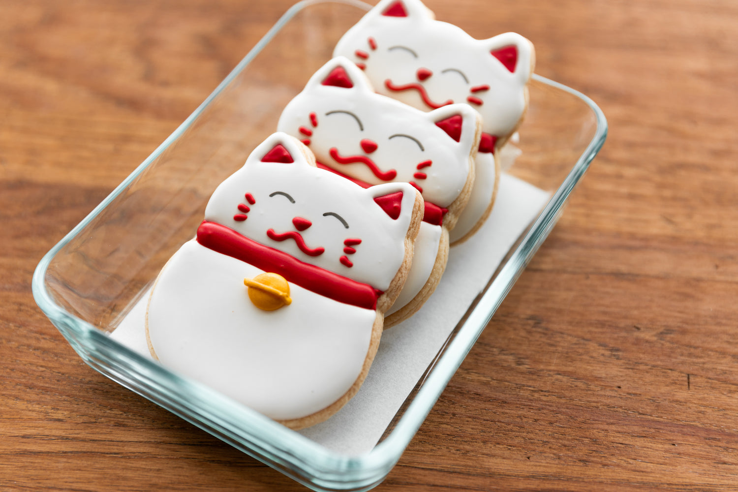 Three freshly baked cookies neatly placed in a transparent container